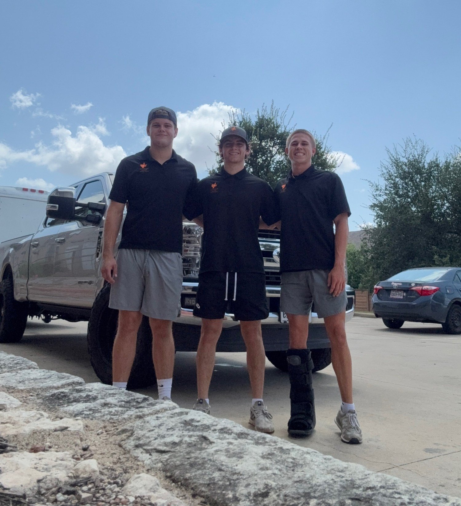 The Settled in Texas moving team standing together in front of their truck